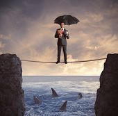 pic of future  - Concept of insurance with businessman on the rope - JPG 