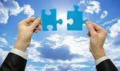image of puzzle  - puzzle in hand isolated on sky background - JPG 