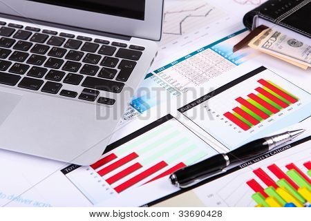 Picture or Photo of Financial paper charts and graphs on the table