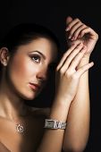 pic of watch  - Woman with silver jewelry on dark background - JPG 