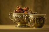 stock photo of religion  - A vintage bowl of dates and a cup of tea - JPG 