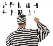 stock photo of lag  - Convict prisoner jailbird is counting days in jail - JPG 