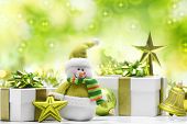 stock photo of holidays  - Snowman and gift boxes on abstract background - JPG 