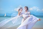 stock photo of beach  - beautiful couple on the beach in wedding dress - JPG 