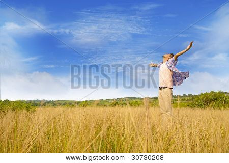 Picture or Photo of Man worshiping god shot at yellow grass