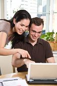 picture of bill  - A happy couple paying bills by using online banking at home - JPG 