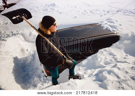 Poster: Man cleans snow