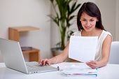 stock photo of home  - Woman working at home on a laptop computer - JPG 