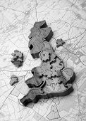 stock photo of puzzel  - Wooden 3D puzzel of the UK placed ontop of an Ordinance Survey map - JPG 