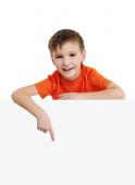 stock photo of over white  - Cute smiling little boy above is the blank white banner and points on it - JPG 
