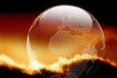 pic of wireframe  - Glossy wireframe earth with cloudy sunset as the backdrop - JPG 