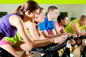 image of competition  - Group of five people in gym or fitness club exercising their legs doing cardio training - JPG 