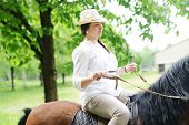 image of horse  - Beautiful girl riding a horse in countryside - JPG 