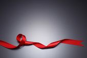 stock photo of black  - Red ribbon isolated on the black background - JPG 