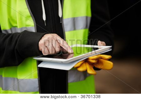 Picture or Photo of Construction worker using digital tablet