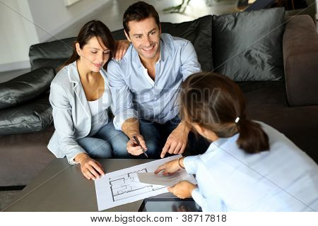 Picture or Photo of Couple signing financial terms for future property