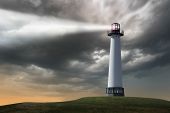 stock photo of outdoor  - Lighthouse beaming light ray over stormy clouds - JPG 