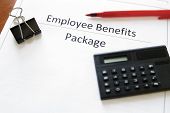 stock photo of employee  - employee benefits package with calculator and pen - JPG 