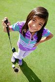 stock photo of golf  - Young female golf player standing next to the hole - JPG 