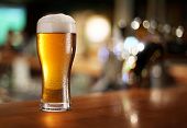 picture of objects  - Glass of light beer on a dark pub - JPG 