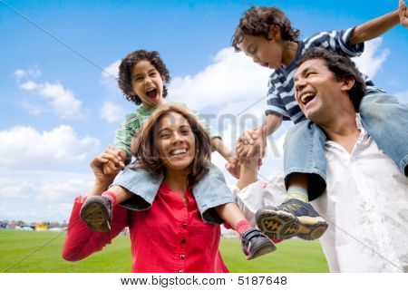 Picture or Photo of Happy family having fun in front of their house