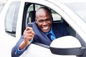 picture of inside  - happy african vehicle buyer inside his new car with car key - JPG 