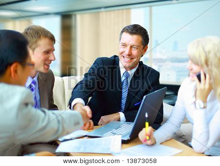 Picture or Photo of Business people shaking hands, finishing up a meeting