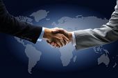 picture of handshake  - Handshake with map of the world in background - JPG 
