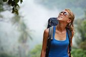 picture of young  - Young tourist with backpack walking in tropical forest - JPG 
