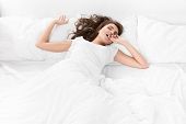 stock photo of home  - young woman sleeping on the white linen in bed at home - JPG 