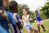 picture of children  - Children and recreation group of happy multiethnic school kids playing tug - JPG 