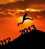 picture of holidays  - Man jump over 2013 number to embrace the new year - JPG 