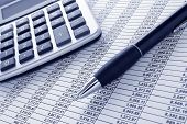 foto of columns  - Ballpoint ink pen and calculator on a financial spreadsheet statement with columns of numbers for an accounting budget finance reconciliation - JPG 