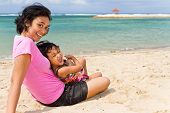stock photo of beach  - Asian ethnic mother and little girl happy vacation on the tropical beach - JPG 