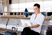 stock photo of computer  - young attractive businesswoman using tablet computer at airport - JPG 