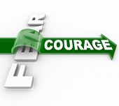 stock photo of succeed  - The word Courage riding an arrow over and overcoming Fear - JPG 