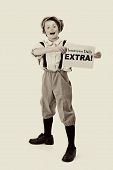 stock photo of newspaper  - old fashioned newsboy holding up newspaper with space for a headline - JPG 