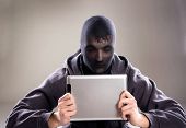 foto of fraud  - Dangerous man in mask with tablet on isolated background - JPG 