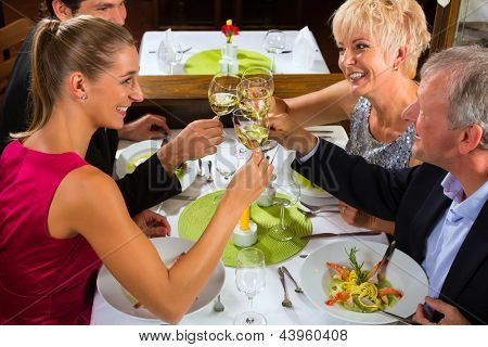 Picture or Photo of Family, mother and father with adult children and daughter or son in law �??�?¢??fine dining in nice restaurant or hotel