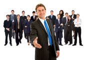 pic of handshake  - business man giving a handshake and a group behind - JPG 