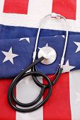 pic of health  - American Health Care concept with stethoscope on folded flag - JPG 