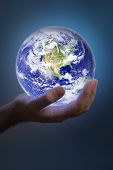 stock photo of earth  - Man holding a glowing earth in his hand - JPG 