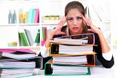 picture of people  - tired business woman with documents in her workplace - JPG 