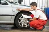 stock photo of failure  - mechanic repairman inspecting car body during automobile car maintenance at auto repair shop service station - JPG 